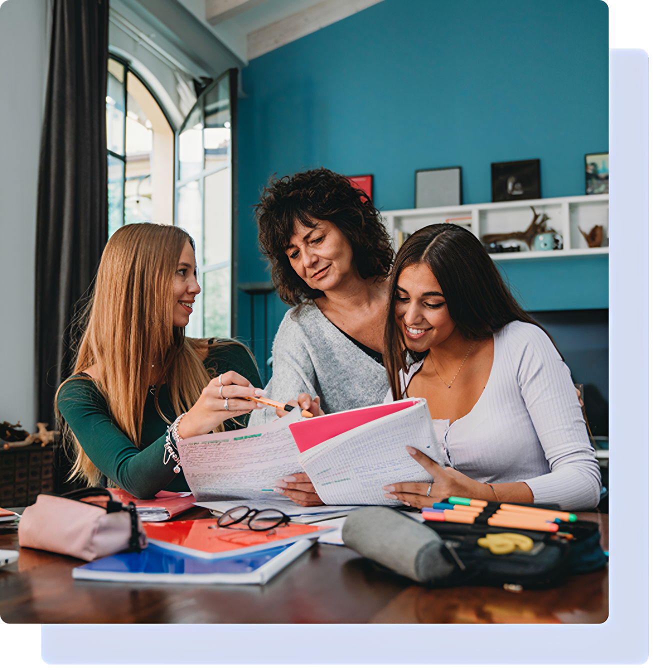 Three people studying together at a table.