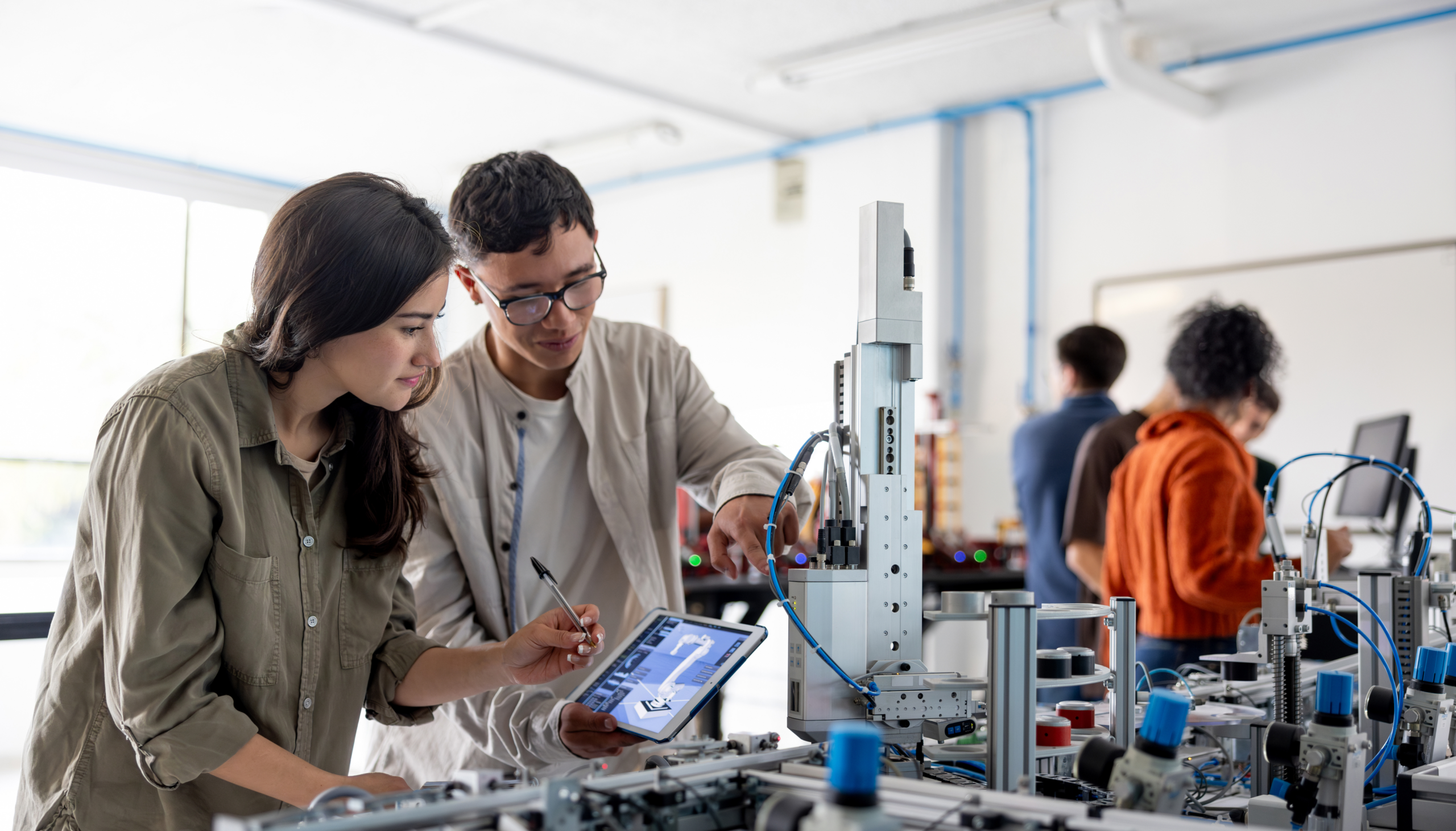 People collaborating in a technology lab setting.