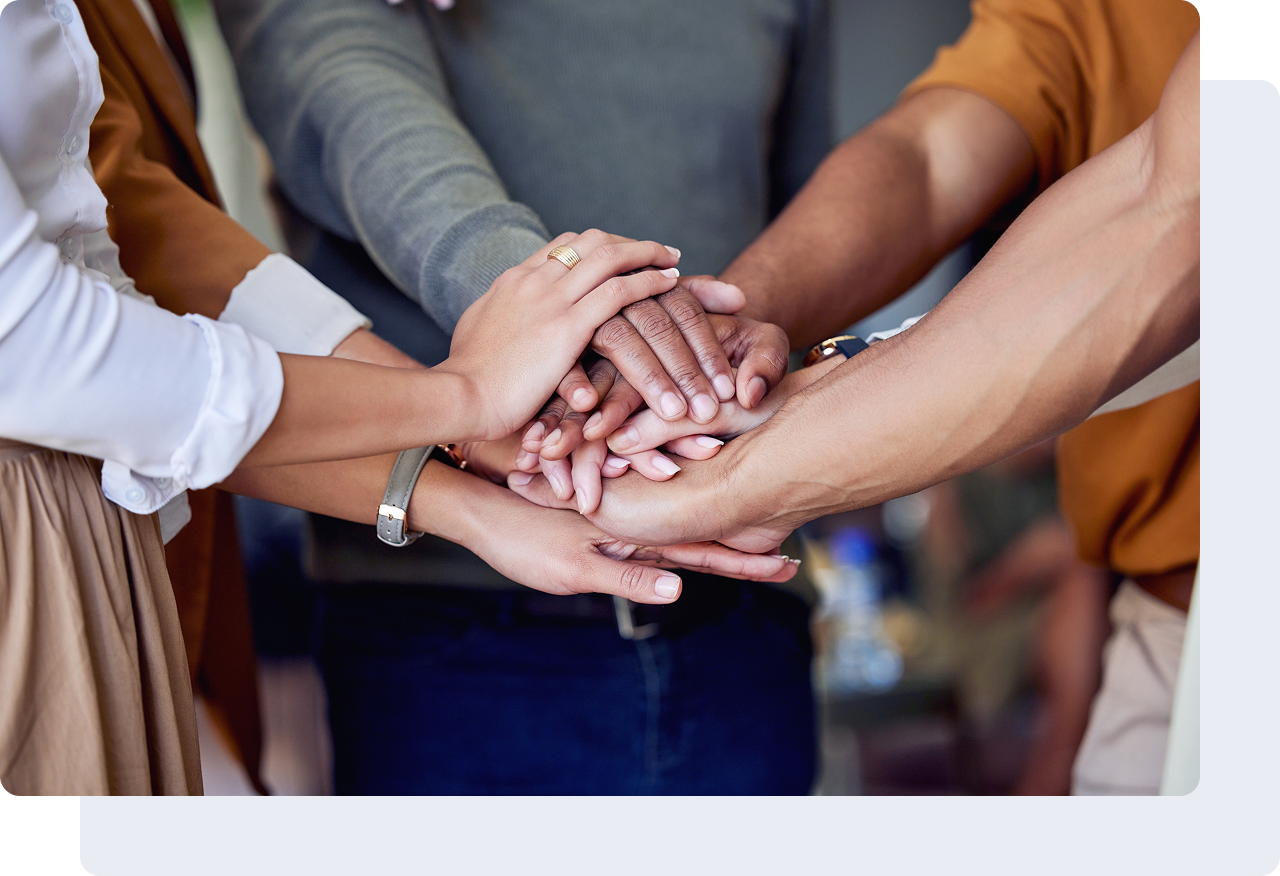 Hands joined together in unity gesture.