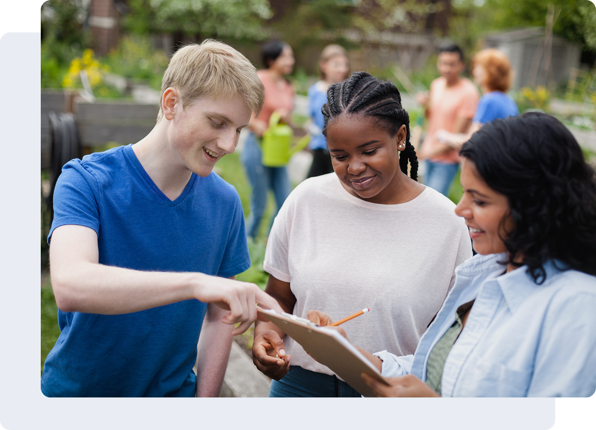 Group discussing plans in a community garden.