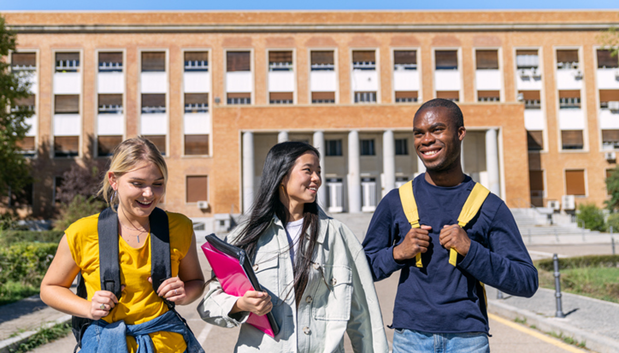 Students walking in front of school building.