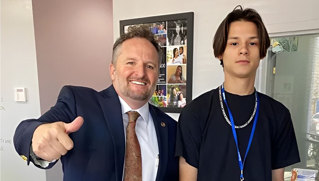 Man giving thumbs up with another person.