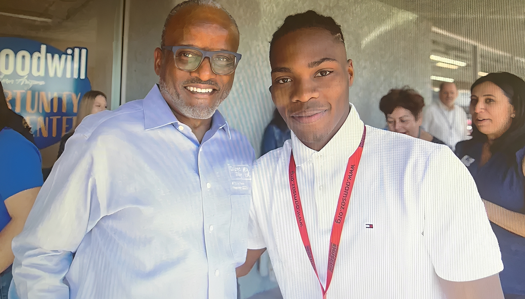 Two people smiling at an event.